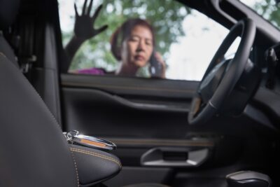 A women is locked out her vehicle.