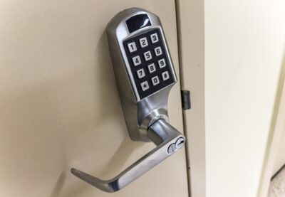 A keypad lock is pictured on a commercial door.