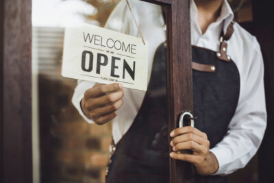 A shop owner locks the door.