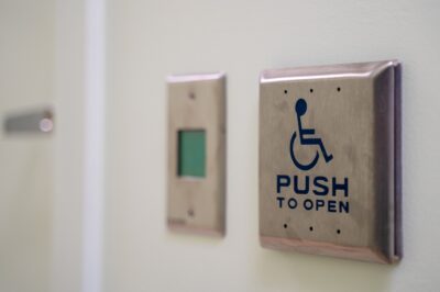 A push-to-open sign on an automatic door opener is pictured.